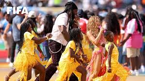 Young Ugandan dancers performing on a large stadium stage