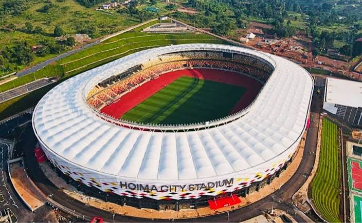 A modern football stadium exterior under a clear sky