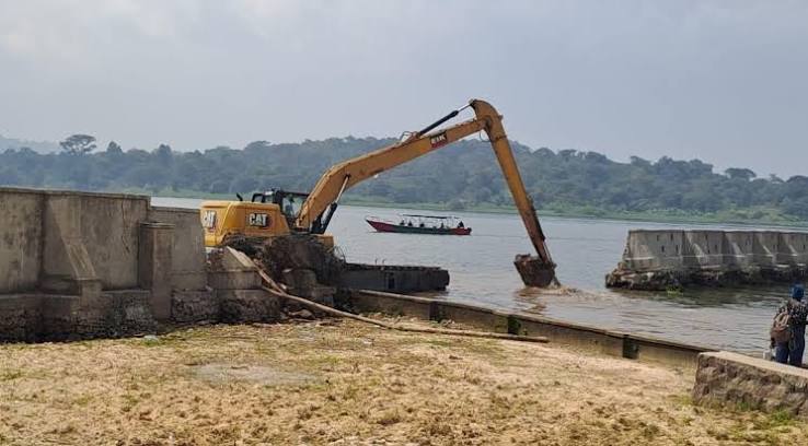An excavator working near a lakeshore