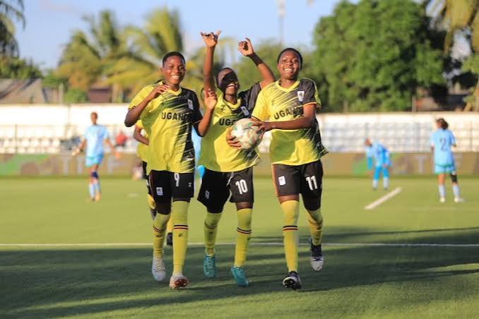 Young female footballers celebrating a goal
