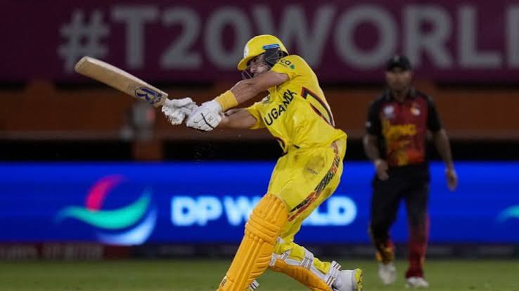 A cricket match in progress with players on the pitch