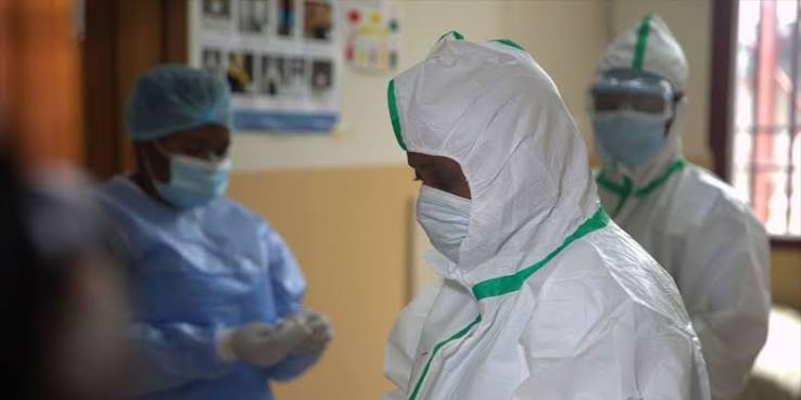 Health workers in protective equipment at a clinic